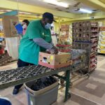 volunteer packing donated food box